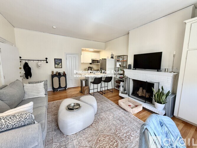 A kitchen with white cabinets and a refrigerator with magnets on it.