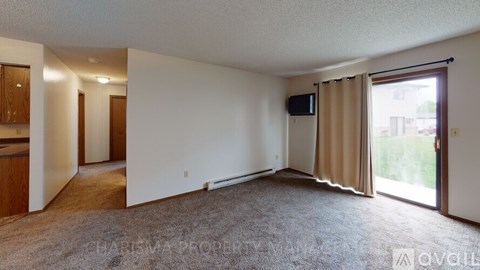 A living room with a sliding glass door leading to a balcony.