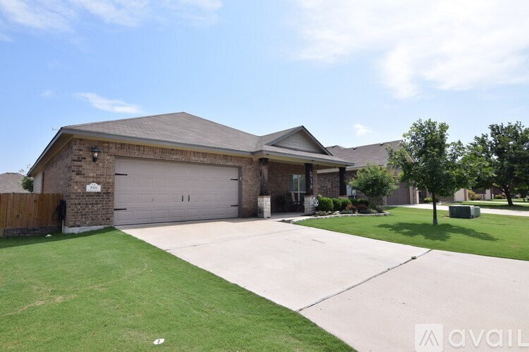 A house with a garage and a driveway in front.