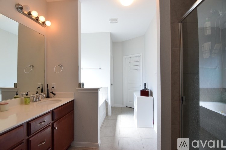 A bathroom with a sink, mirror, and a white cabinet.