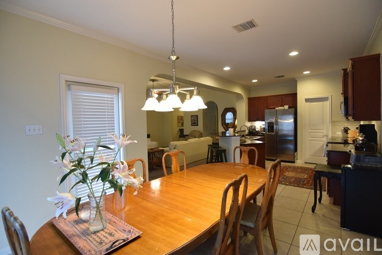 A dining room with a wooden table and chairs.