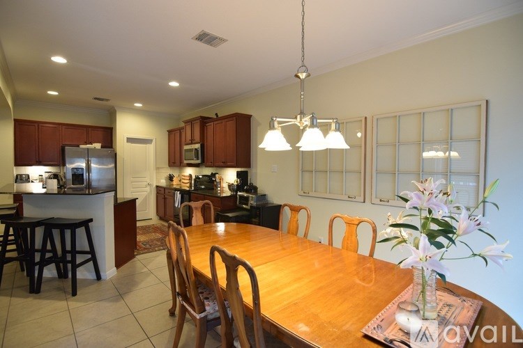 A kitchen with a dining table and chairs.