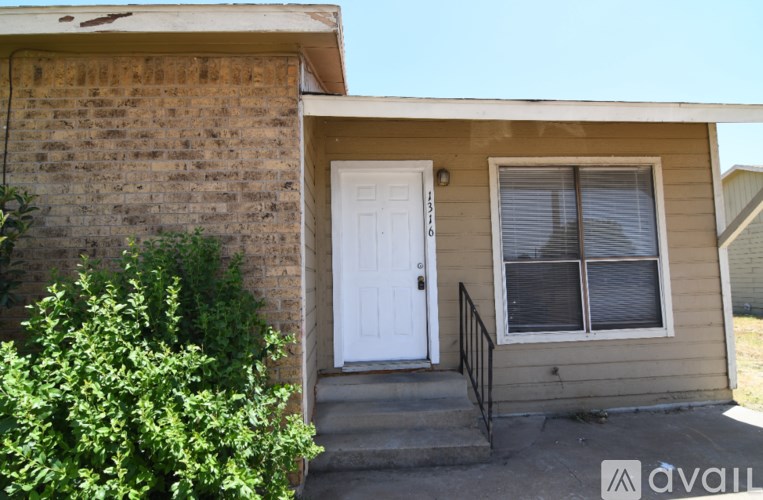 A house with a white door and a window with blinds.