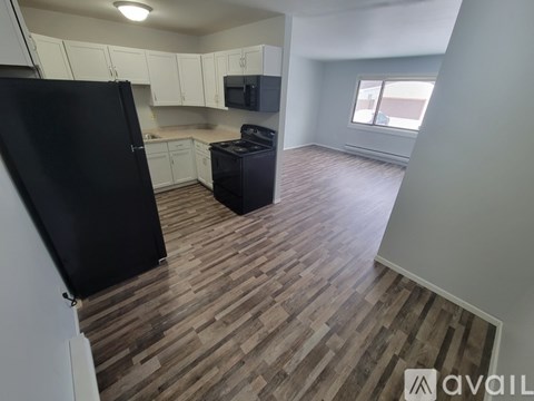 A kitchen with a black fridge and a black stove.