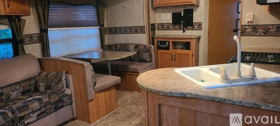 A kitchen area with a table and chairs is available.