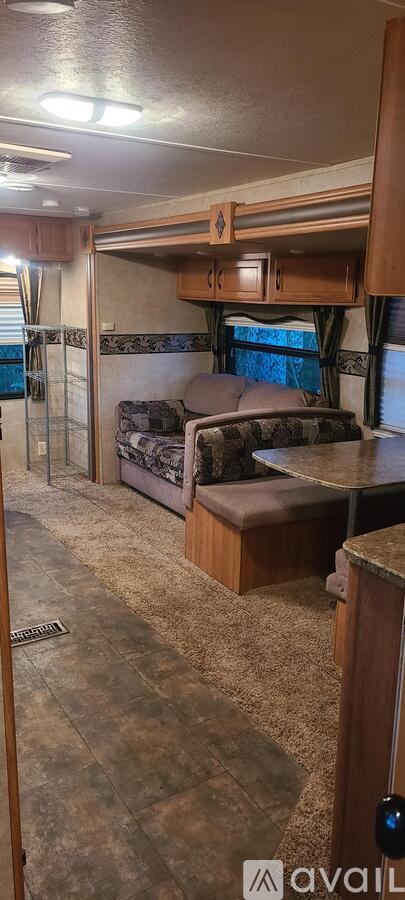 A caravan interior with a couch and a bed.