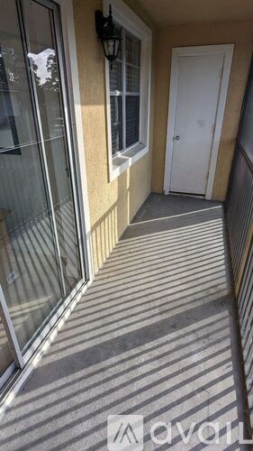 A narrow alley with a white door at the end.