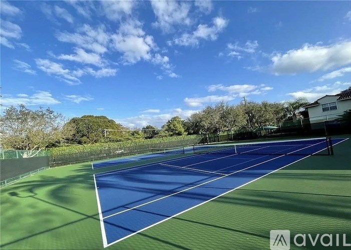A tennis court with a blue and green surface and white lines.