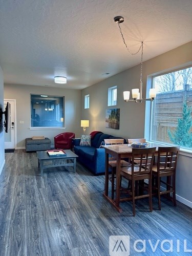 A living room with a blue couch and a wooden coffee table.