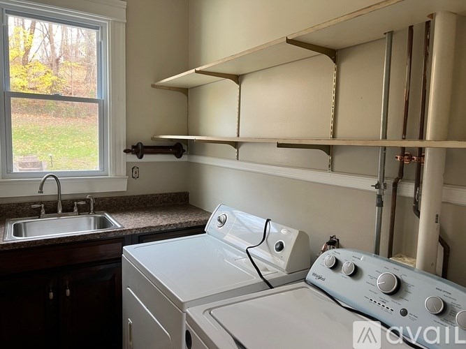 A small laundry room with a washer and dryer.