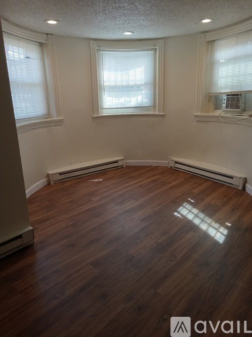 A room with wooden floors and white walls.