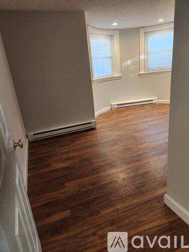 A room with wooden floors and white walls.