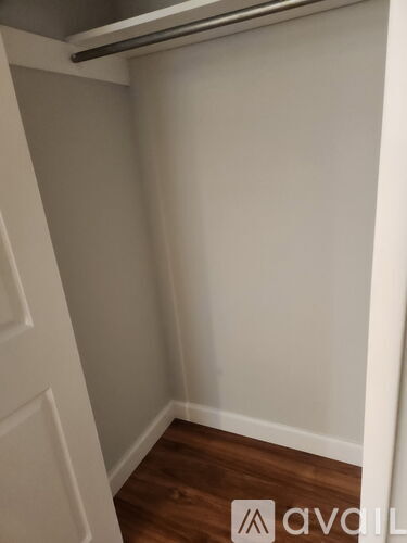 A white door is on the left and a white wall is on the right.