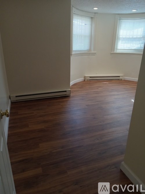 A room with wooden floors and white walls.