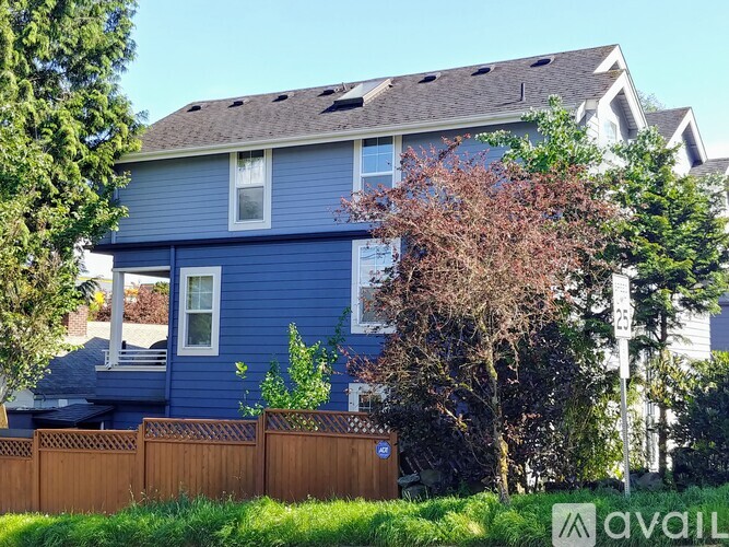 A blue house with a brown fence in front.