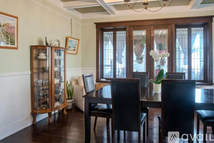 A dining room with a table set for four.