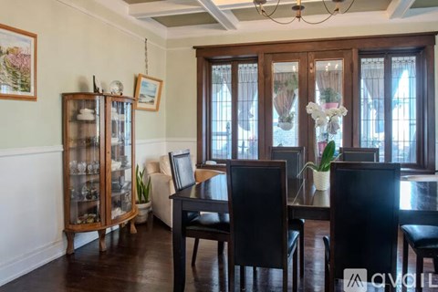 A dining room with a table set for four.