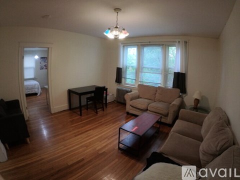 A living room with a couch, chair, and table.