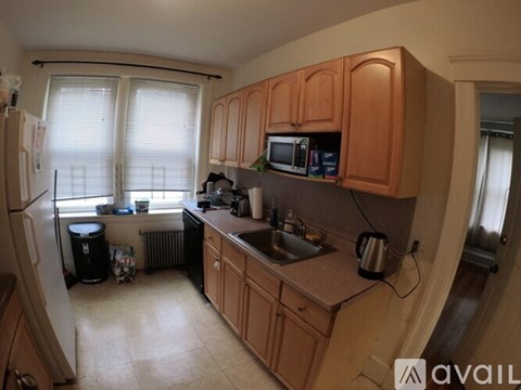 A kitchen with wooden cabinets and a sink.