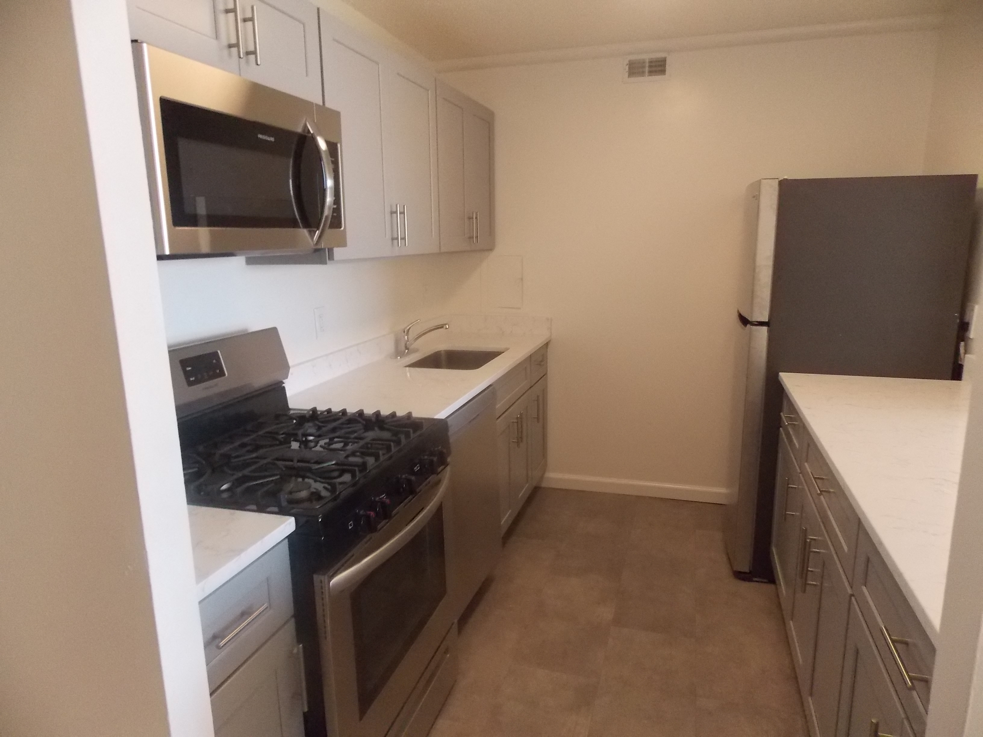 a kitchen with stainless steel appliances and white cabinets