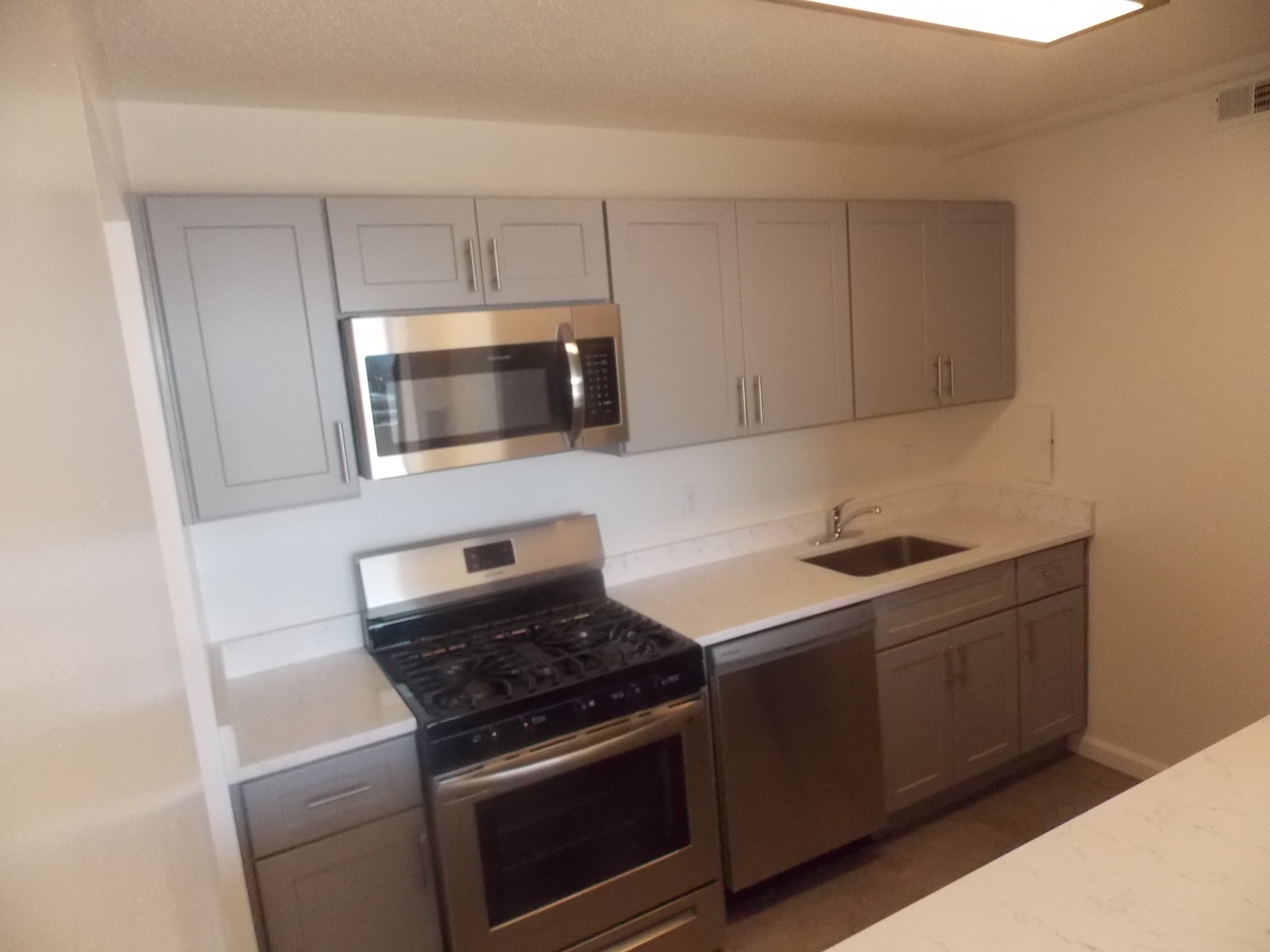 a kitchen with stainless steel appliances and white cabinets