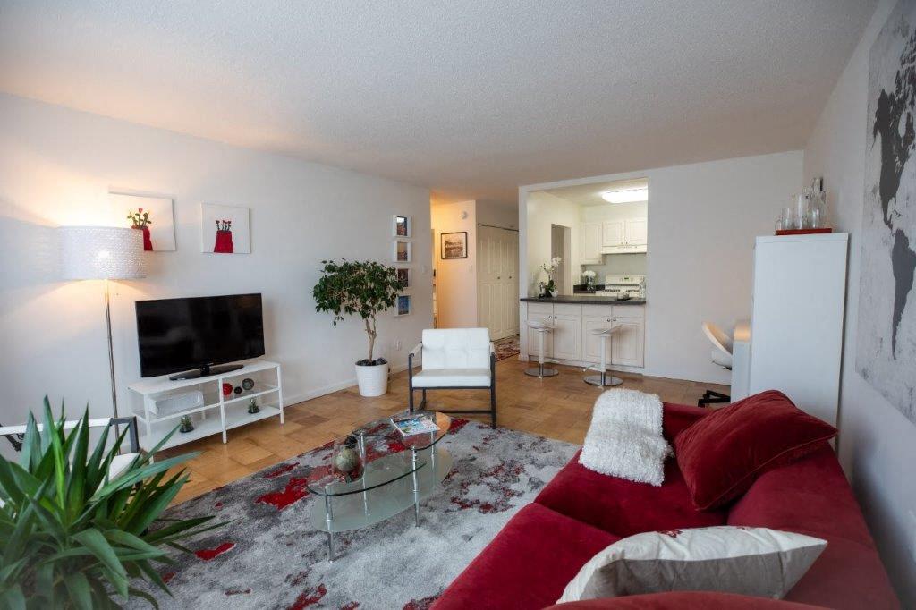 a living room with a red couch and a television