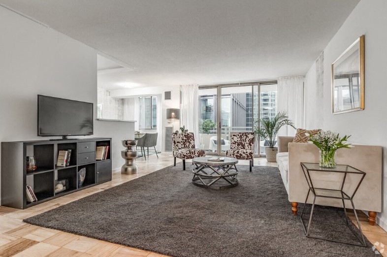 the living room of an apartment with a couch and a tv
