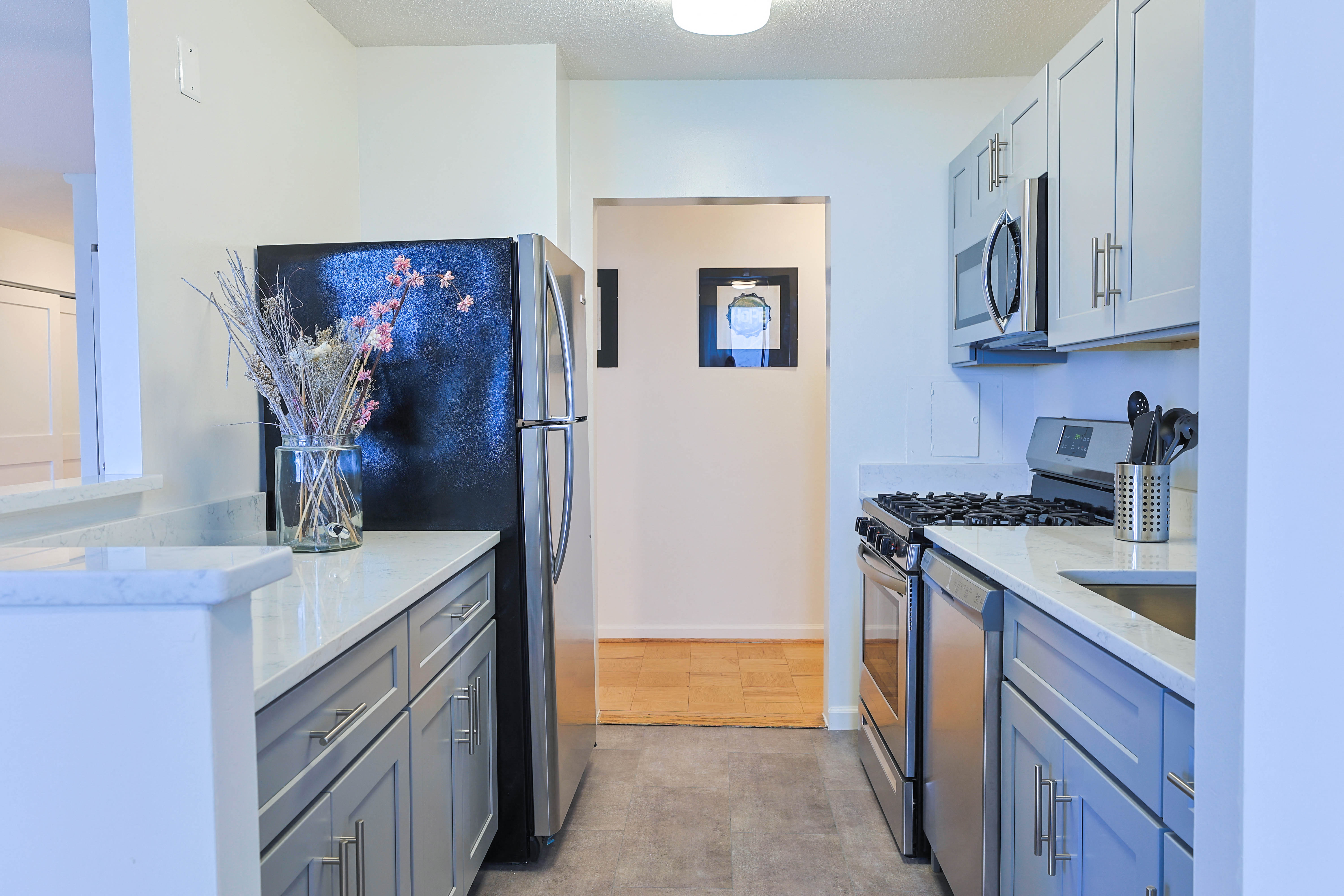 a kitchen with stainless steel appliances and white cabinets