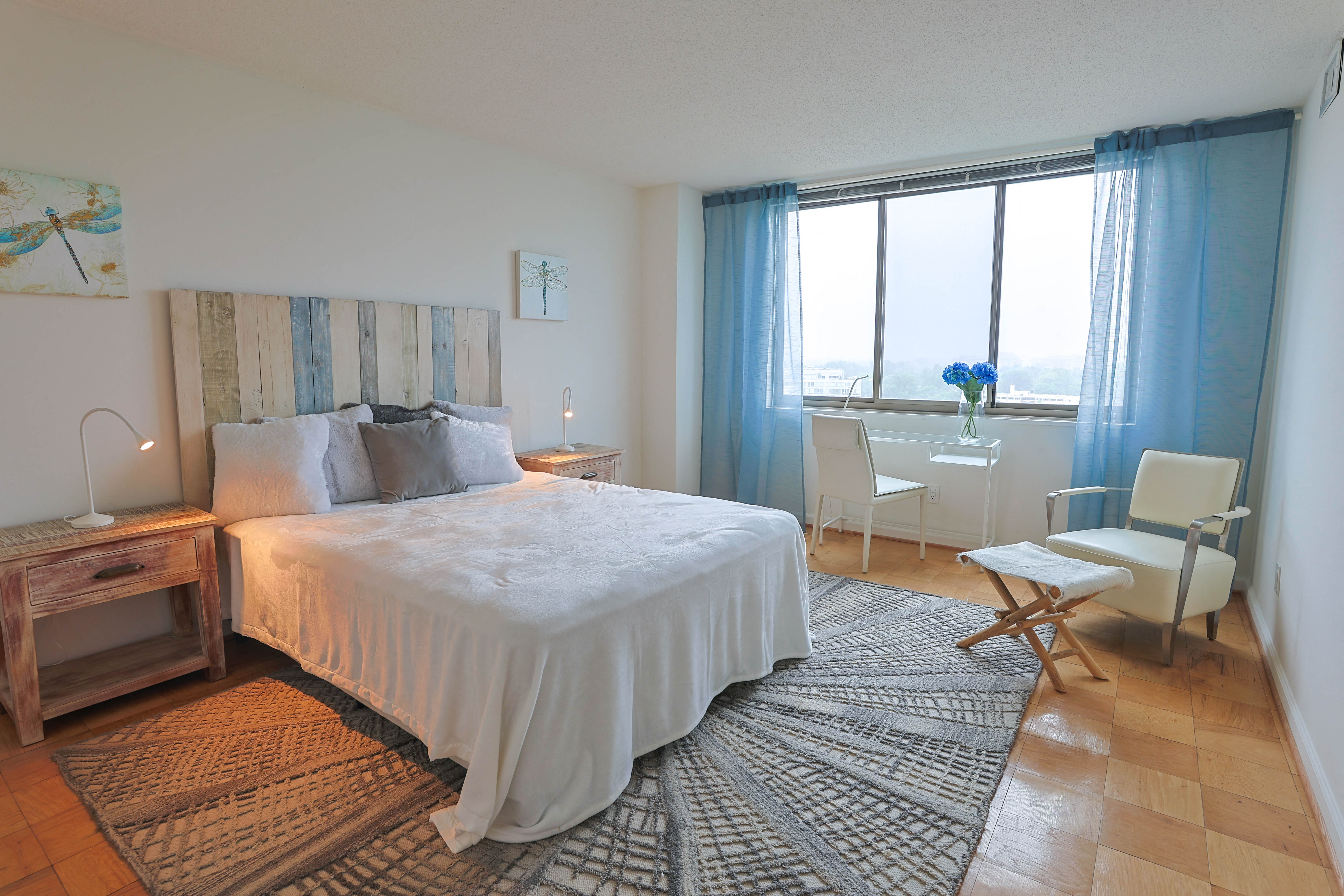 a bedroom with a bed and a desk and a window