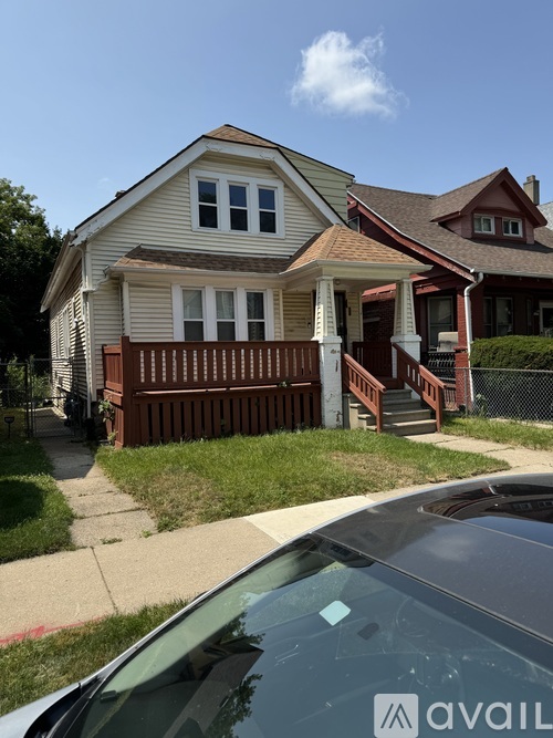 A house with a car parked in front.