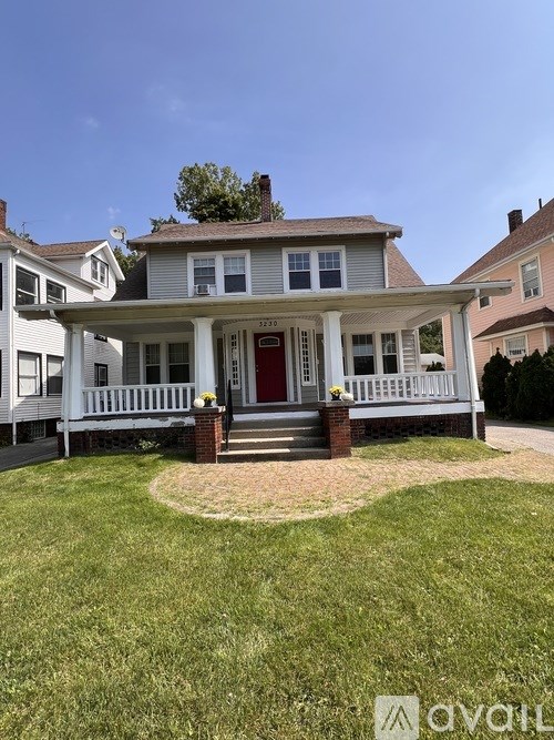 A house with a red door and white porch.