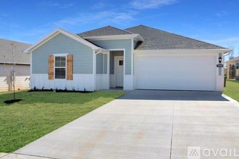 A two-story house with a garage is available for rent.