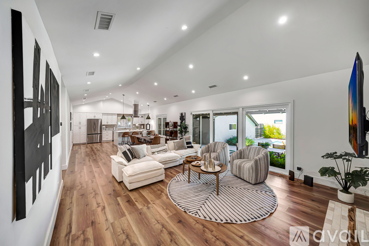 A living room with a white couch and a coffee table.