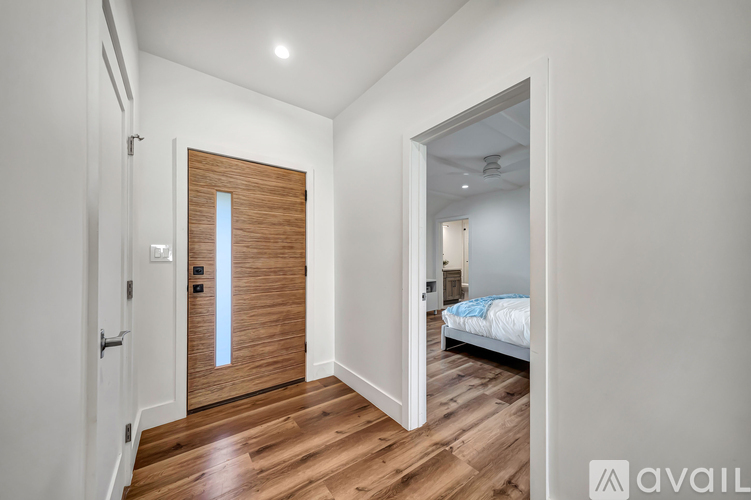 A bedroom with a bed and a wooden door.