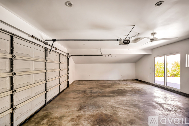 A spacious garage with a concrete floor and white walls.