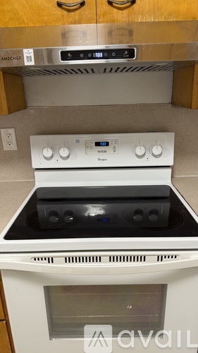 A white oven with a digital display and control panel.