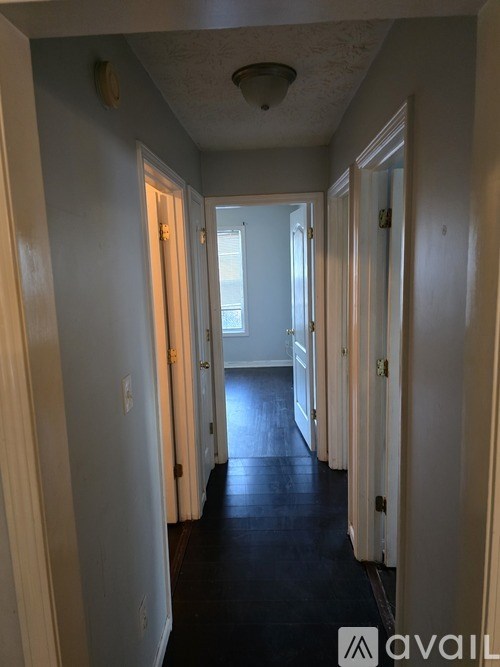 A long hallway with doors on both sides.
