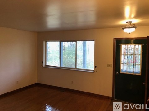 A room with a window and a door.
