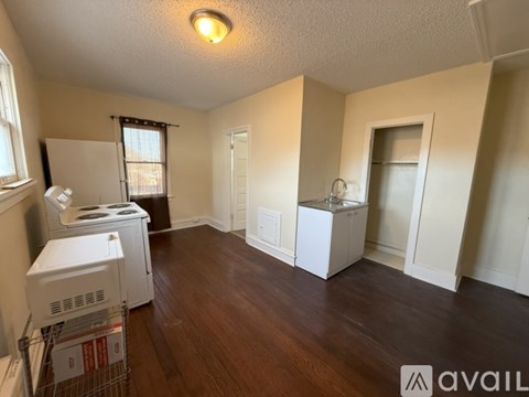 A room with a white fridge, a white ice maker, and a white washer and dryer.