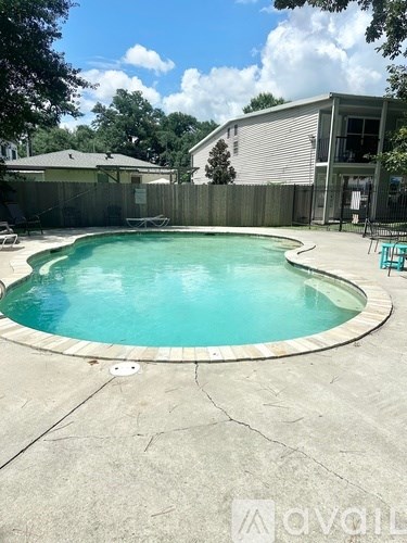 A small pool with a concrete floor and a concrete border.