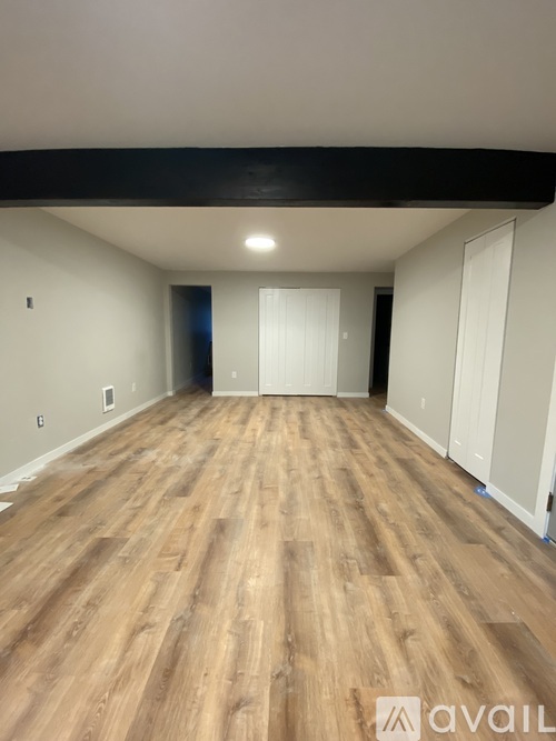 A kitchen with white cabinets and a black countertop.