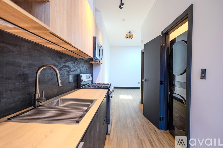 A modern kitchen with a sink and a refrigerator.