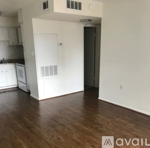 A kitchen with white cabinets and a white fridge.