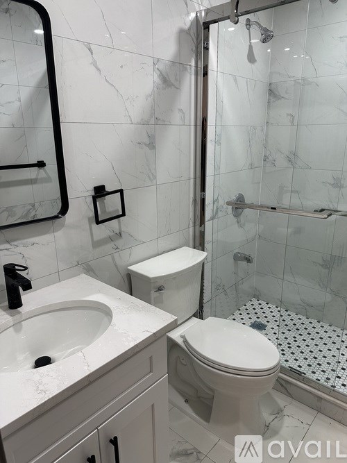 A white toilet sits next to a sink in a bathroom.