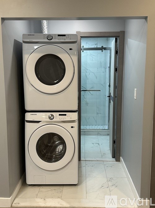 Two front loading washing machines in a laundry room.