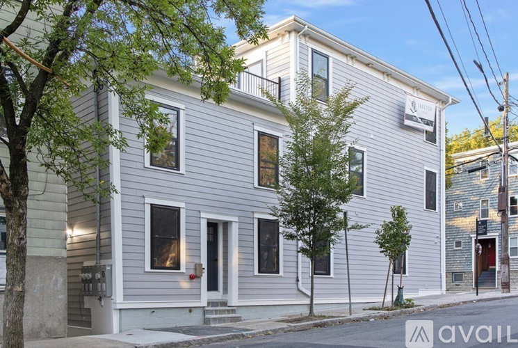 A two-story house with a balcony on the second floor.