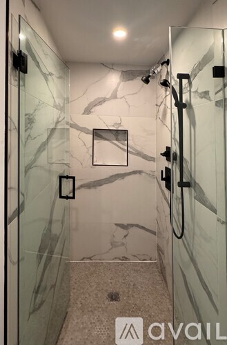 A white sink in a bathroom with a mirror above it.