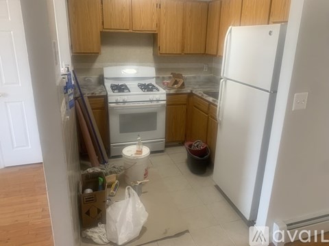 A kitchen with a white fridge and a white stove.