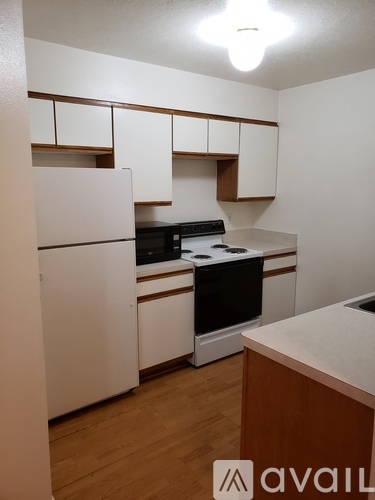 A kitchen with a microwave, oven, and cabinets.