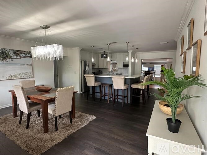 A dining room with a wooden table and chairs.